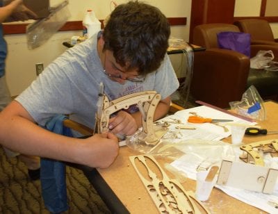 A student builds a robotic arm